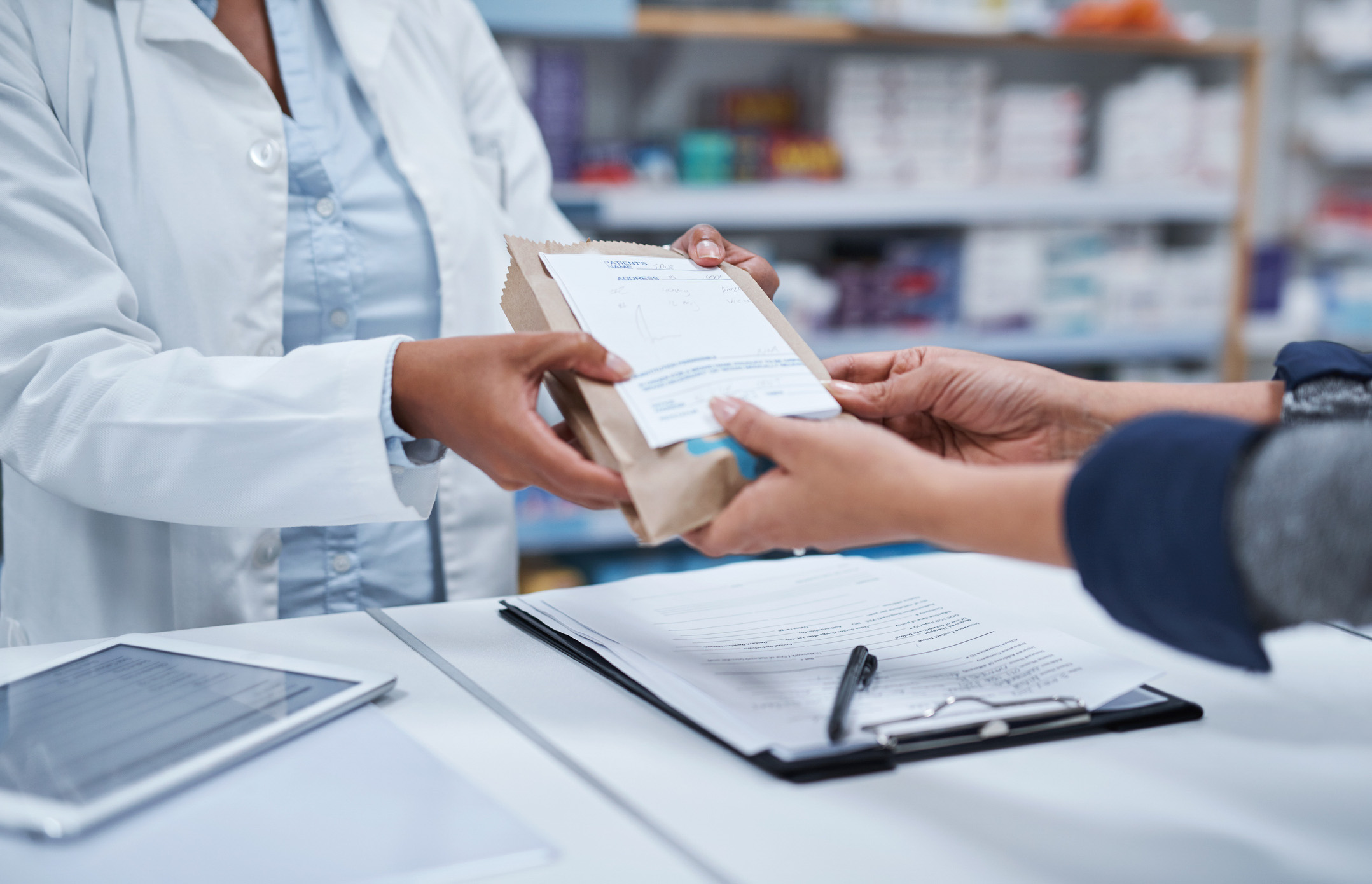 Person receiving a prescription from a pharmacist