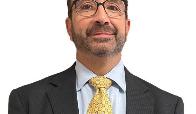 man with glasses in a suit and tie