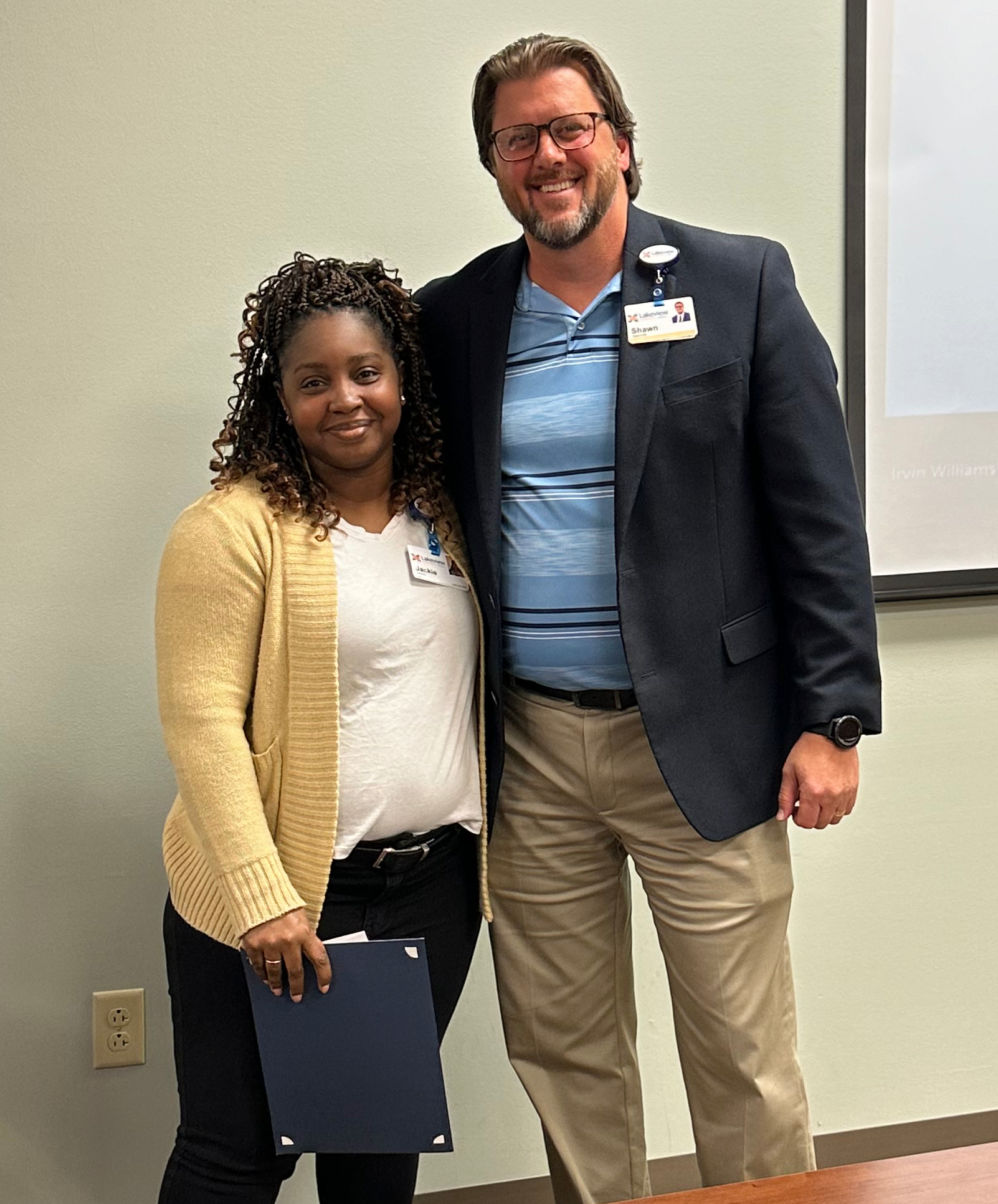 Jackie (left) with Shawn Salamida, president of Lakeview Center (right) 