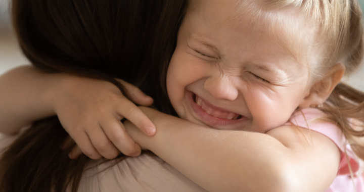 Little girl hugging woman