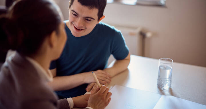 Adult man with Down Syndrome meeting with case worker