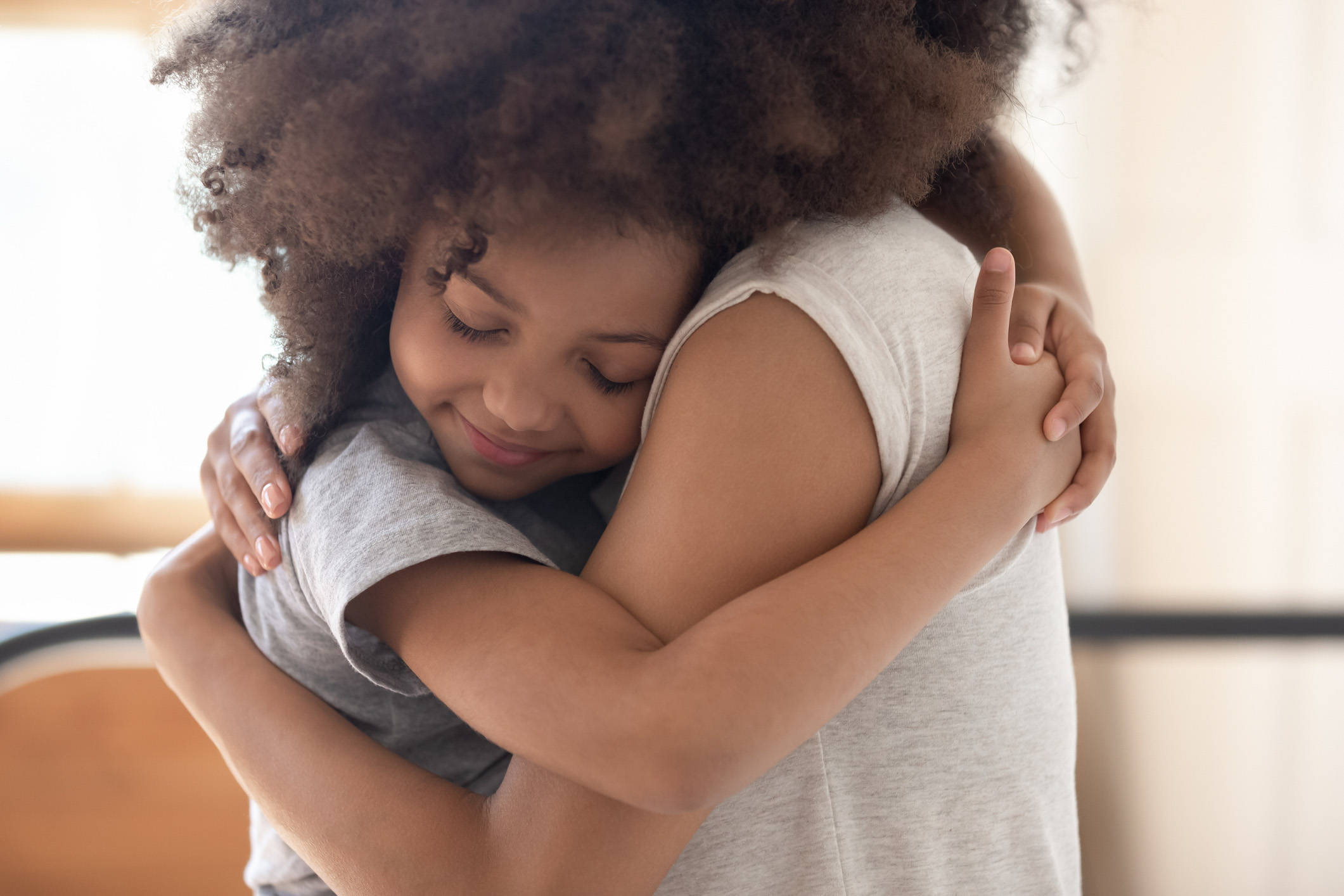child hugging adult