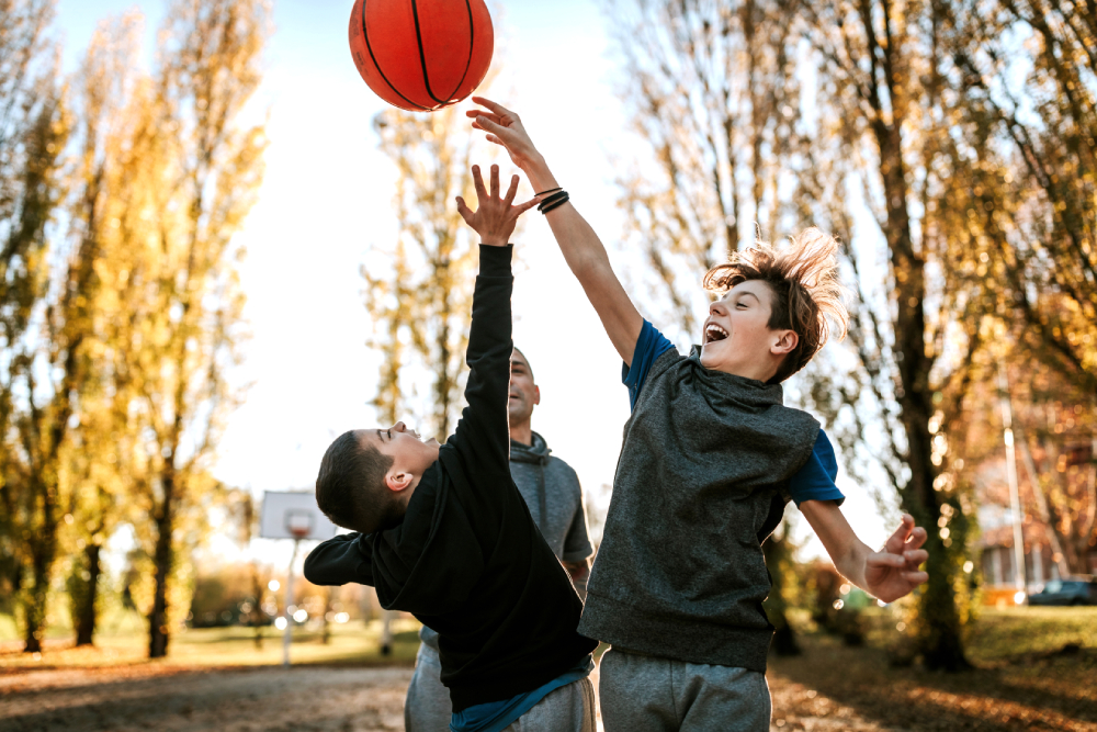 Teen boys playing basketball